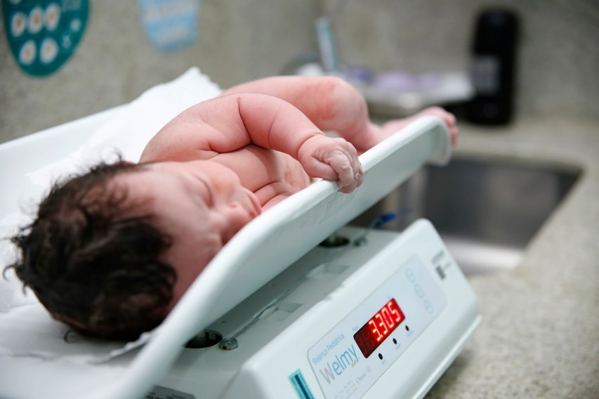 Newborn baby on scale