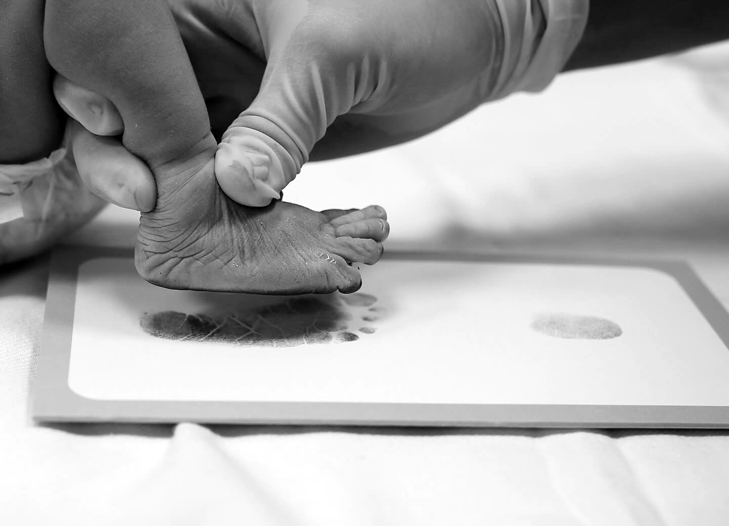 Taking footprints from newborn baby