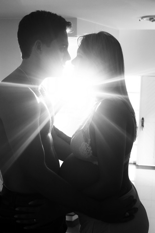 Artistic photograph of pregnant woman with partner