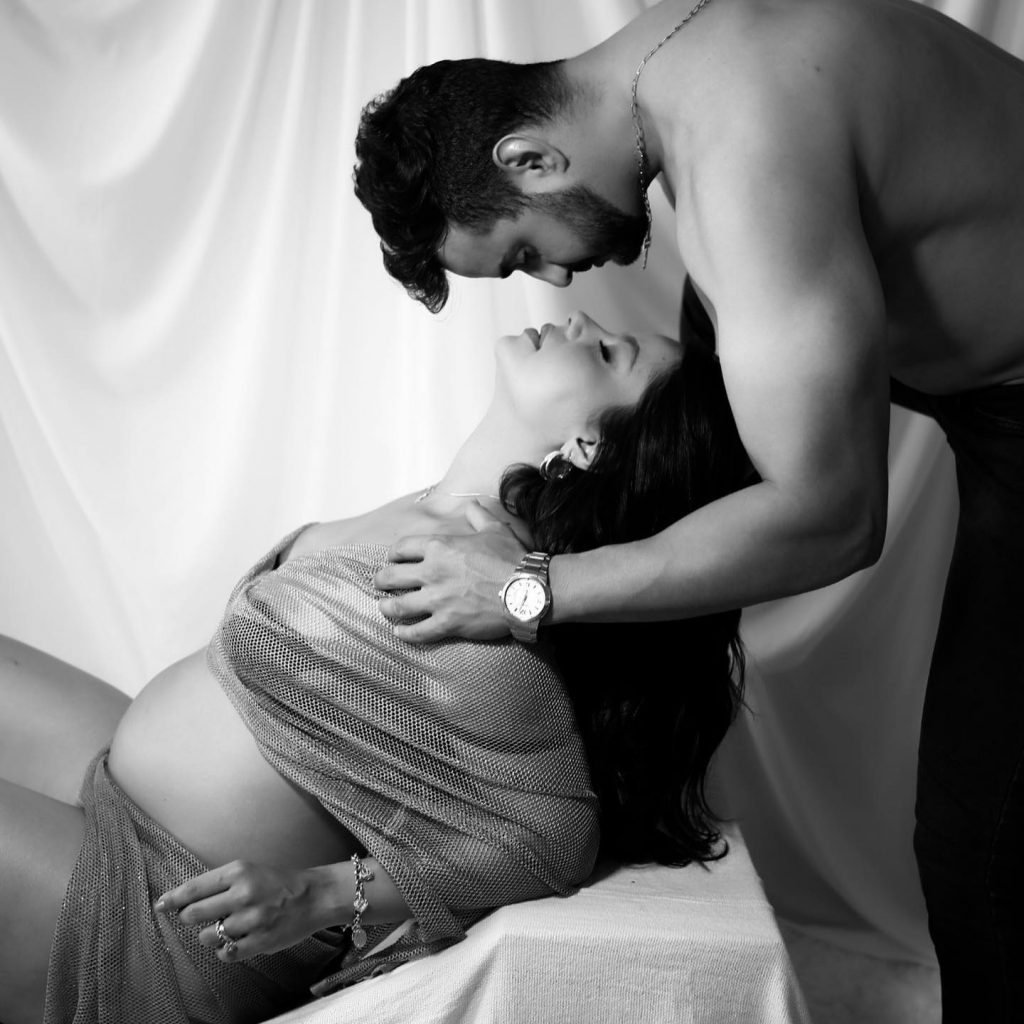 Artistic photograph of pregnant woman with partner