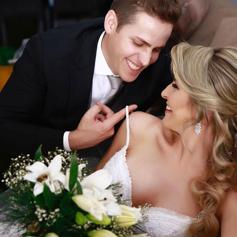 Newlywed couple smiles at each other