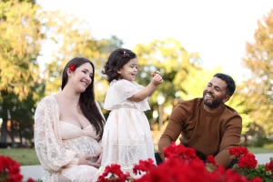 Photo of a family havinf fun at Congress Park in Saratoga, NY, during a maternity photo shoot