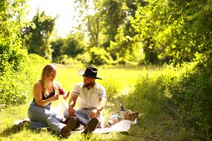 Newly engaged couple smiling together during their proposal picnic in Albany, NY